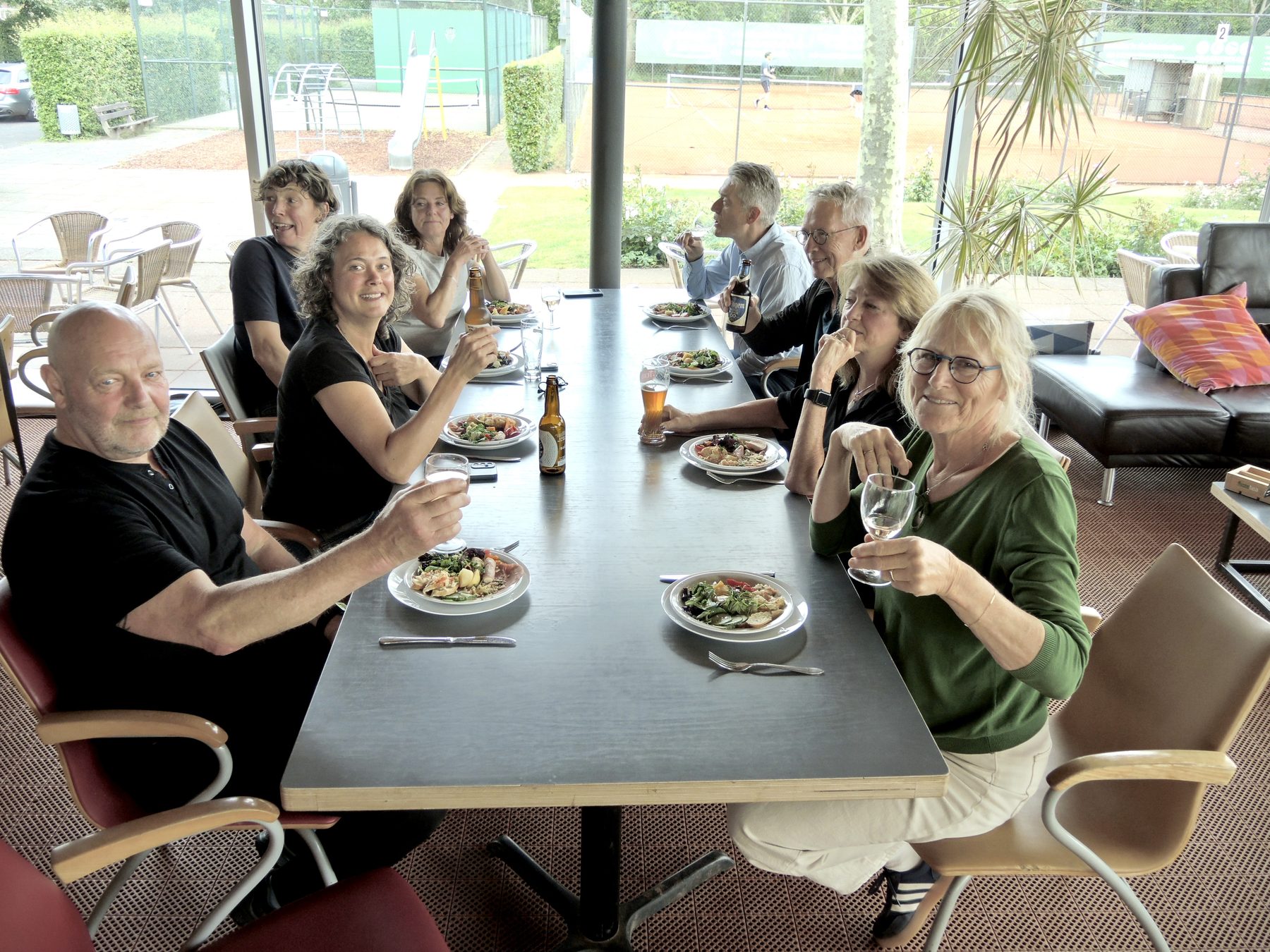 Deelnemers dineren samen aan een lange tafel